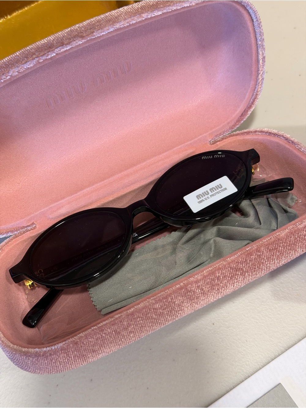 Miu Miu Black Oval Sunglasses with Dark Lenses